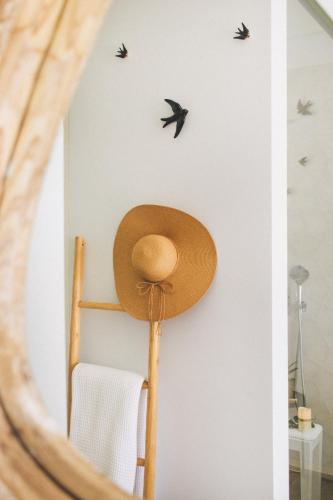 a hat on a wall with birds on it at Casa LNNoa Boutique Room whit private pool in Lagos