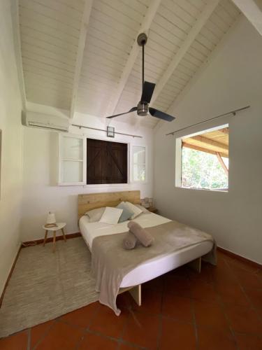 a bedroom with a bed and a tv on the wall at Villa NO&LO in Sainte-Anne