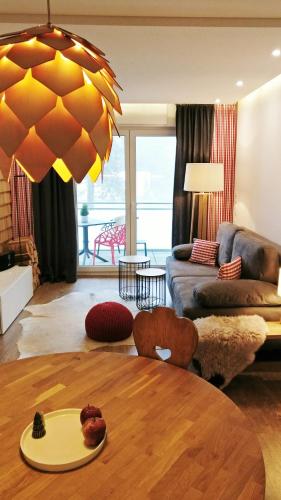 a living room with a table and a couch at Auerhahn Feldberg in Feldberg