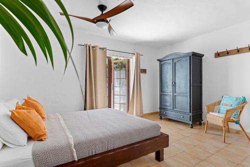 a bedroom with a bed and a blue cabinet at Villa Munay in Puerto del Carmen