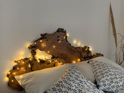 a bed with white pillows and lights on a wall at Porto Antico in Bari