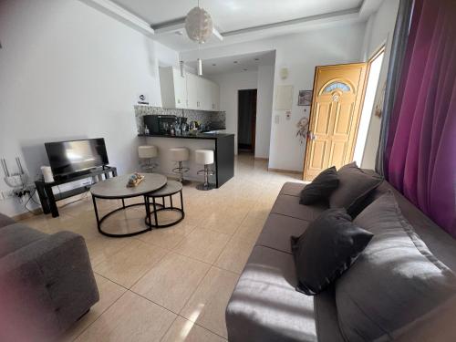 a living room with a couch and a table at Charalambous Apartment in Paphos