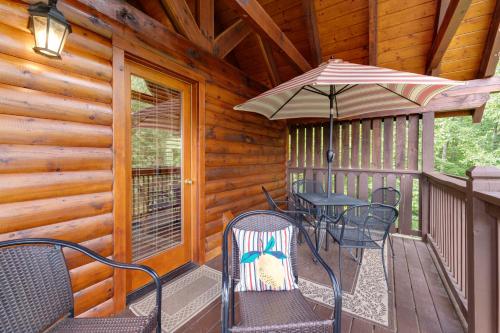 a porch with a table and chairs and an umbrella at The Laughing Salamander in Dupont Springs