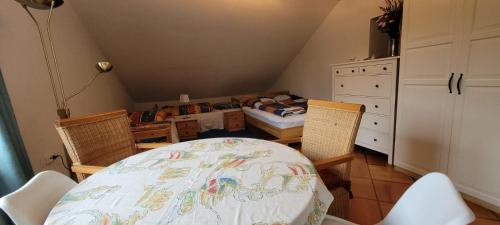 a room with a table and chairs and a bedroom at Am Birkenhain in Titisee-Neustadt