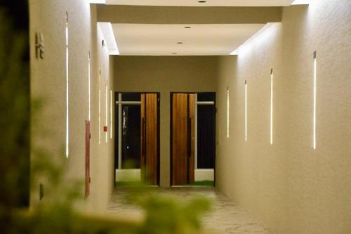 a hallway with wooden doors in a building at Hadeer Chalet in Riyadh