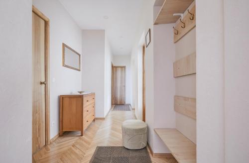 a hallway of a home with white walls and wooden floors at Old Town apartment in Kaunas