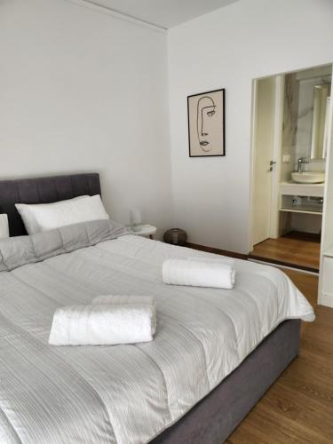 a bedroom with a large bed with two towels on it at Harmony Elegant Central Apartment in Rhodes Town