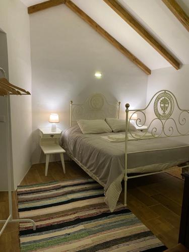 a bedroom with a bed and a side table at Monte da Venda de Baixo in Santa Margarida da Serra