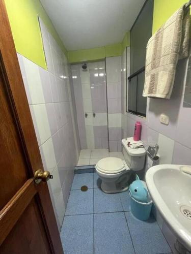 a small bathroom with a toilet and a sink at Julio Reyna Apartamento in Cusco