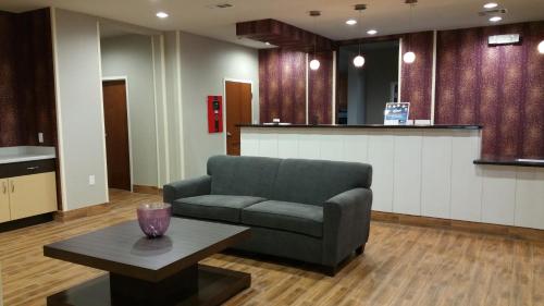 a living room with a couch and a table at Super 8 by Wyndham Carrizo Springs in Carrizo Springs