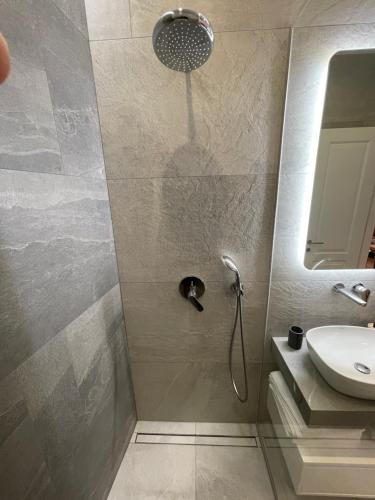 a bathroom with a shower and a sink at Central Apartments Sarajevo in Sarajevo