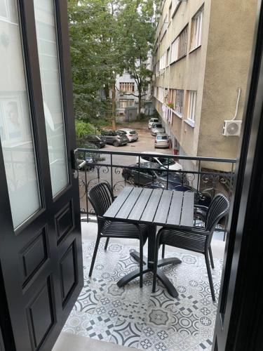 a patio with a table and chairs on a balcony at Central Apartments Sarajevo in Sarajevo