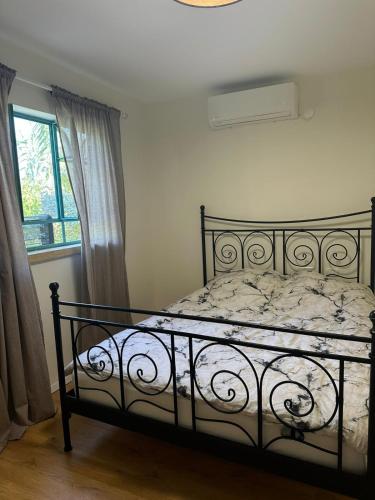 a bedroom with a bed in a room with a window at רגע מושלם in Shave Ẕiyyon