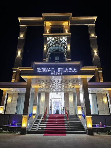 a building with a staircase in front of it with a sign at Royal Plaza in Qarshi