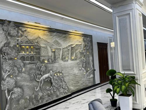a large painting on a wall in a room at Royal Plaza in Qarshi