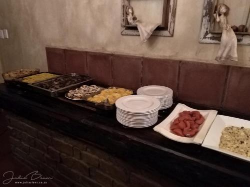 a buffet with plates of food on a table at New Holme Nature Lodge in Hanover Road