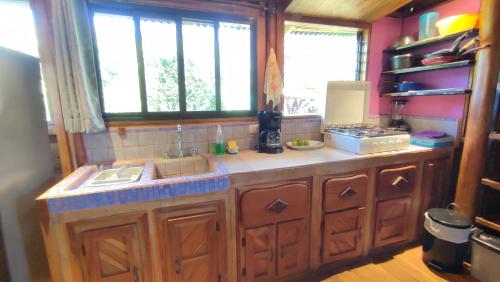 a kitchen with a sink and a counter with windows at Marbella Beach (10min. walk) Nature Lovers & Surf in Marbella