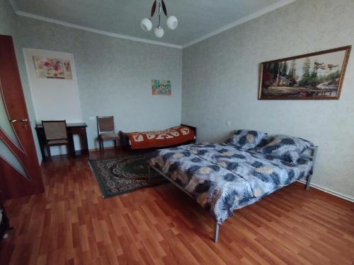 a bedroom with a bed and a table in it at GuestHouse ED&ER near airport in Geghanist