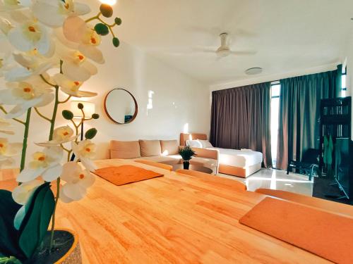 a living room with a couch and a table at Beacon Executive Suite at Georgetown for 10pax and 2 BED ROOM in George Town