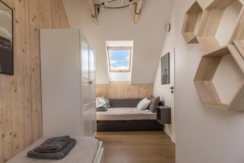 a small room with a bed and a window at Siema Siemiany in Siemiany