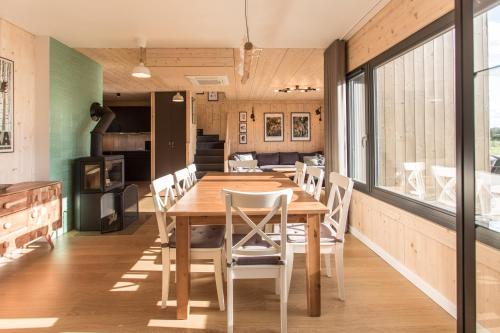 a kitchen and dining room with a wooden table and chairs at Siema Siemiany in Siemiany