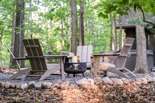 a group of chairs and a table in front of a cabin at Modern Cabin w/Hot Tub & Fire Pit! in Hedgesville