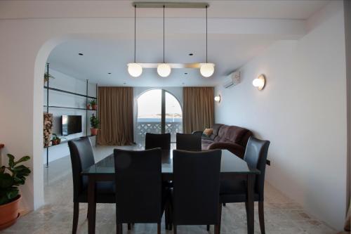 a dining room with a table and chairs at VILLA JOSEPH in St Paul's Bay