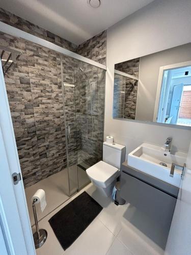 a bathroom with a toilet and a sink and a shower at Casa Pinto in Villacosta