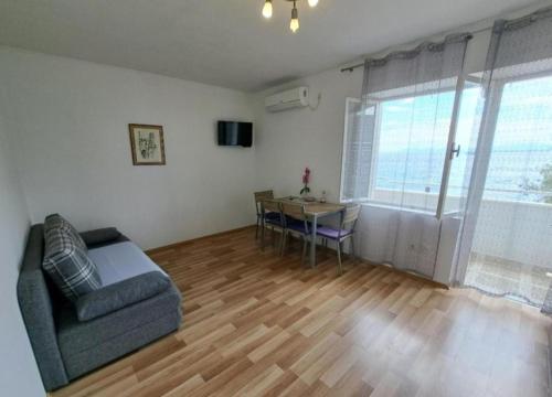 a living room with a couch and a table at Apartmani Ivano in Igrane