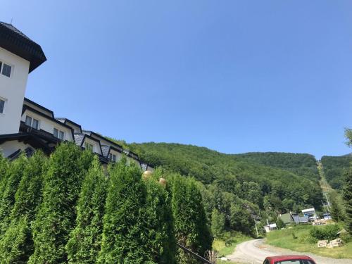 a house on the side of a hill with a road at Planinski Raj - Bela Reka Gondola in Brzeće