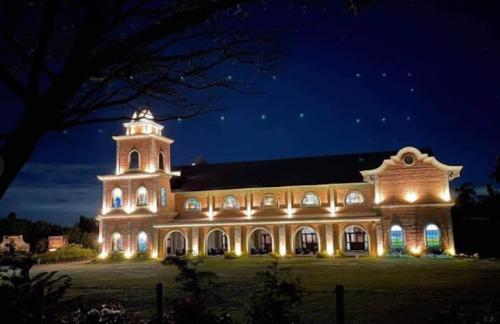 a large building lit up at night with lights at Staycation At Sandari Batulao Overlooking Spot in Tagaytay