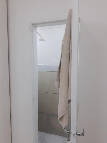a bathroom with a shower with a towel hanging on the door at Hotel SIMPLE in Manaus