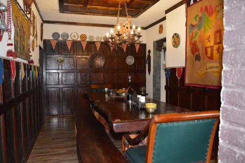 a dining room with a wooden table and chairs at Castillo Medieval in Viña del Mar