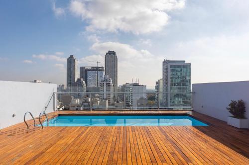 a swimming pool on the roof of a building at Núñez Minimal Apartment Premium in Buenos Aires