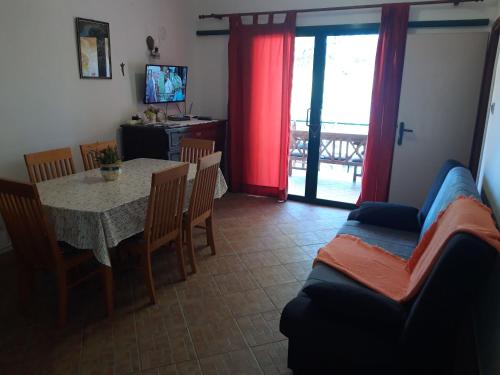 a living room with a table and a couch at Apartment Dijana in Prigradica