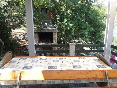 a table sitting on a porch with a fireplace at Apartment Dijana in Prigradica