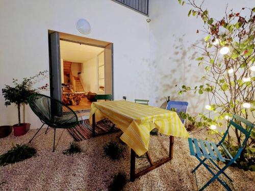 Cette chambre comprend une table, des chaises et un miroir. dans l'établissement Maison centre-ville de Sète, à Sète