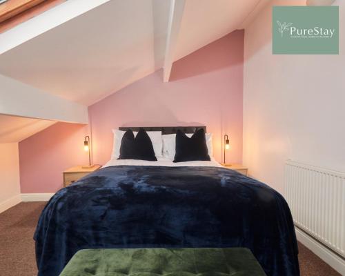 a bedroom with a king sized bed in a attic at Stunning Four Bedroom House By PureStay Short Lets & Serviced Accommodation Bradford With Parking in Bradford