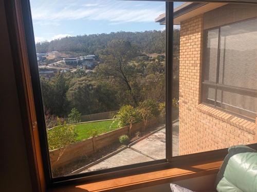 a window with a view of a yard at Front apartment in Howrah with stunning views in Howrah