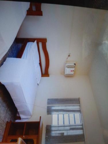 a small room with a bed and a scale at Hotelcoxipo in Cuiabá