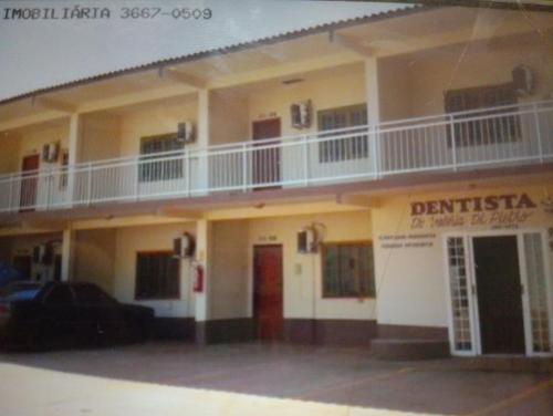 a large building with a balcony on top of it at Hotelcoxipo in Cuiabá