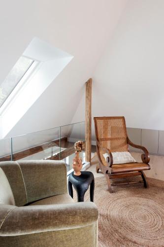 a living room with a couch and a chair at Hus 42 in Fårup