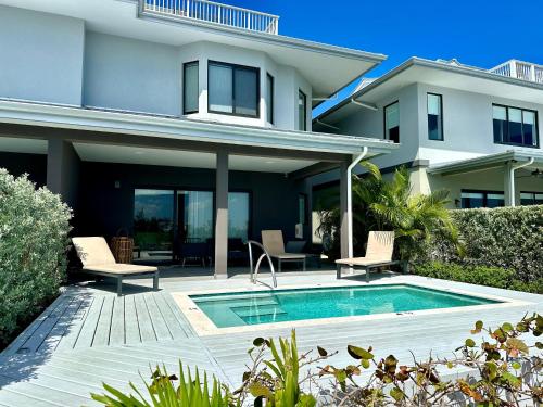 a house with a swimming pool in front of a house at Mahogany Villa 2-A / 4BR 