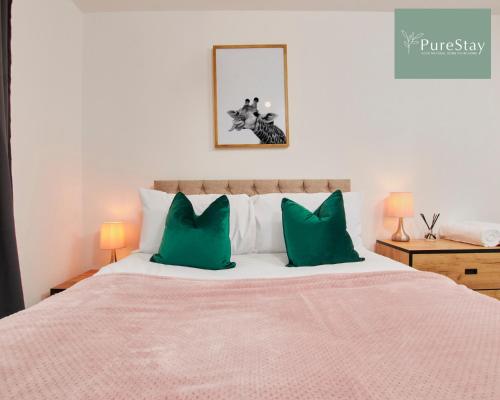 a bedroom with a large bed with green pillows at Perfect for Business Stays in Manchester - 5 Bedroom House By PureStay Short Lets & Serviced Accommodation in Manchester