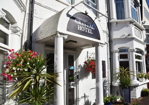 a hotel with a sign on the front of a building at Crystal Hotel & Savour in Cambridge