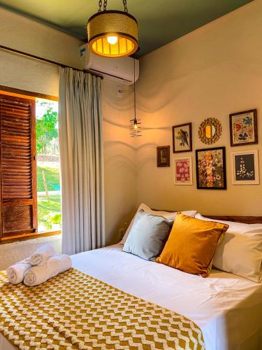 a bedroom with a large bed with a window at Bica D' Água Boutique Hotel in Capitólio