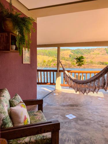 a hammock in a living room with a view at Bica D' Água Boutique Hotel in Capitólio
