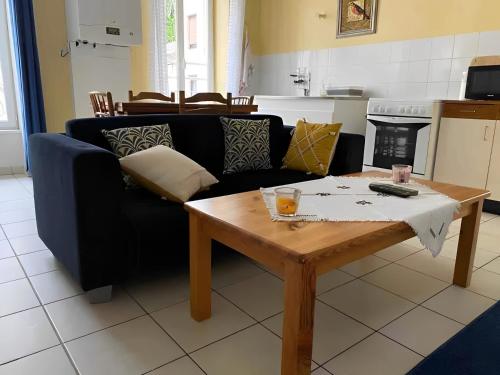 a living room with a couch and a coffee table at Un moment de Détente au cœur de Vals-les-Bains in Vals-les-Bains