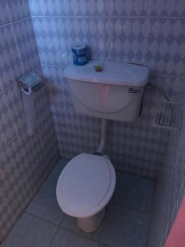 a bathroom with a white toilet in a stall at Christine's Airbnb in Mbale