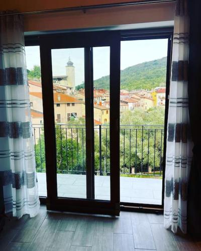 an open window with a view of a city at La Casa Di Emy in Alfedena